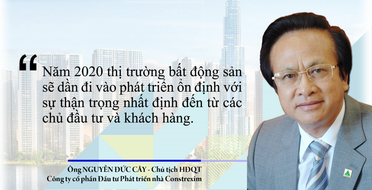 Chân dung người đàn ông trung tuổi, đeo kính trắng, mặc vest xám.