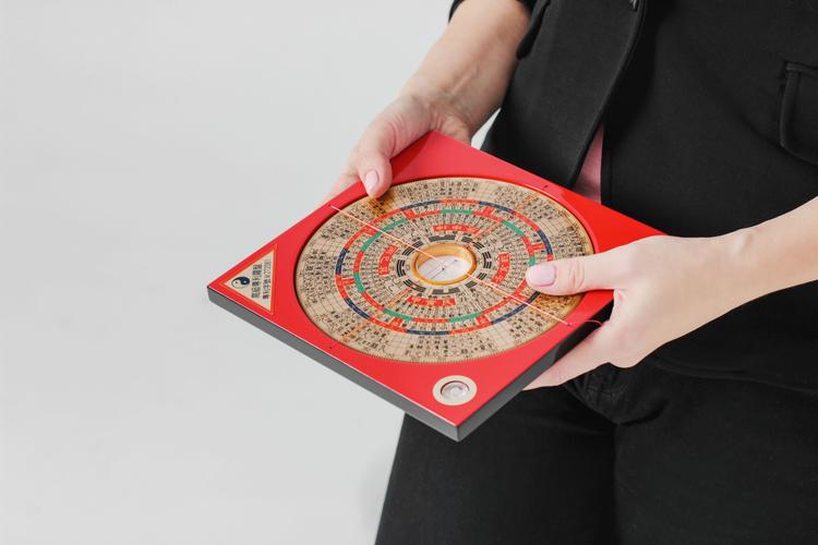 Chinese compass Lopan for Feng Shui technique in female hands is