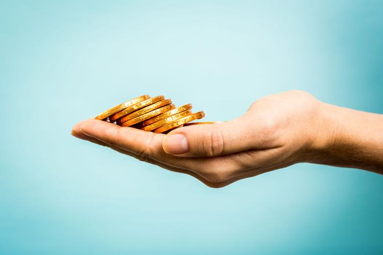 Hand holding golden coins