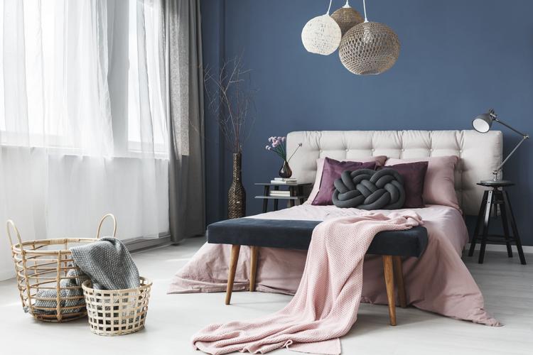 pastel colour room with king-sized bed and a pendant lamp