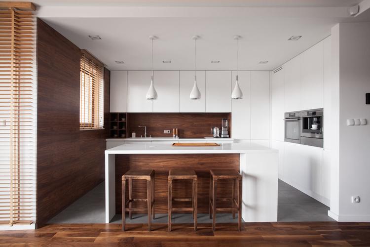 Modern wooden kitchen with white island and dining space