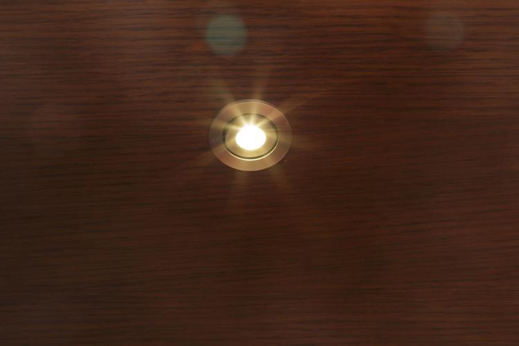 Ceiling downlight on white ceiling, warm light