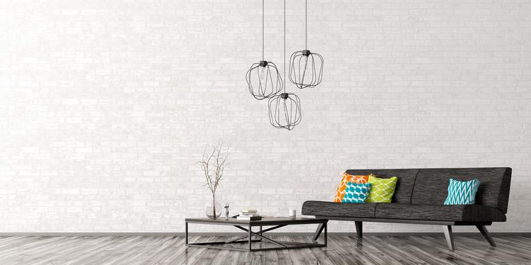interior-of0living-room-with-black-sofa-coffee-table-lamps-over-brick-wall