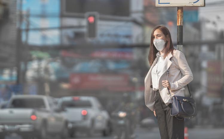 Asian woman are going to work.she wears N95 mask.Prevent PM2.5 d