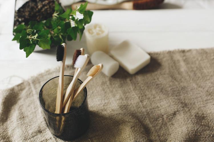eco natural bamboo toothbrushes in glass