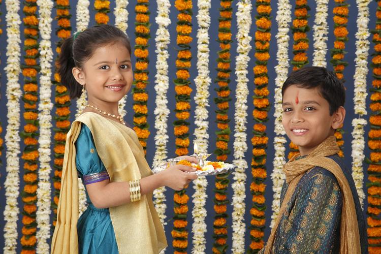 Sister holding aarti thali in front of brother on Rakshabandhan festival