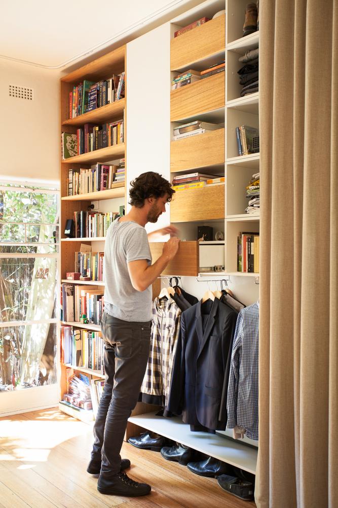 a man is looking through his closet