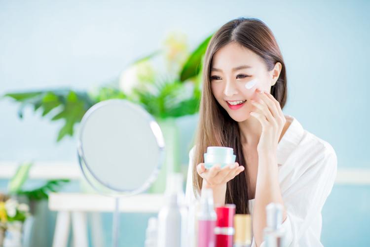 woman apply skin care at home