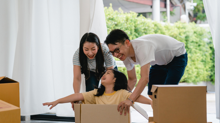Family enjoying time together while unpacking in their new home.