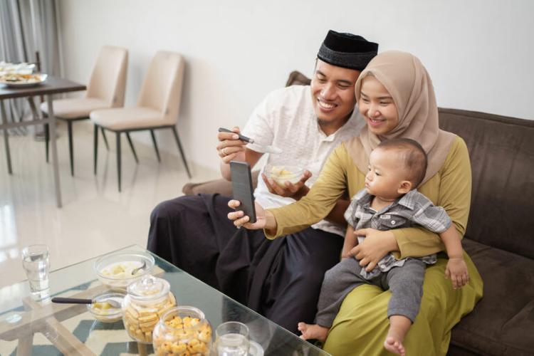 asian young muslim family taking selfie together at home