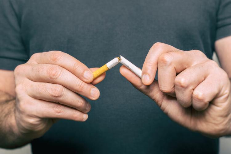 man-smoking-crushing-cigarettes