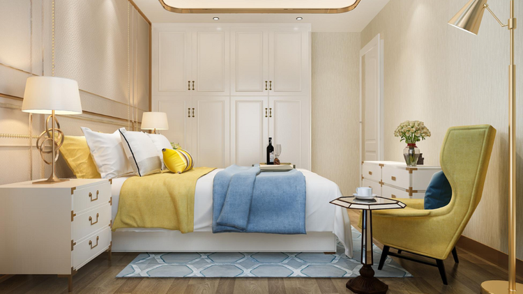 A luxurious, modern bedroom features a large bed with yellow and blue linens