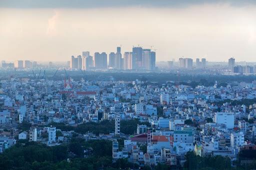 Urban skyline featuring tall towers and apartments.