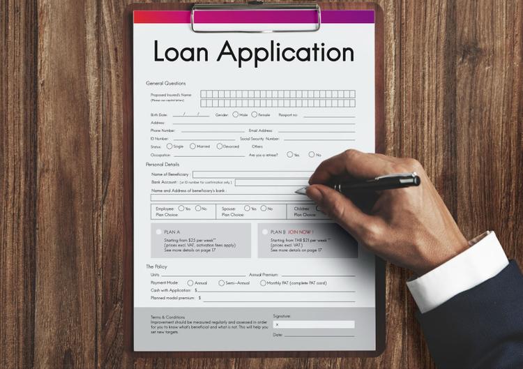 A man filling up a loan application form