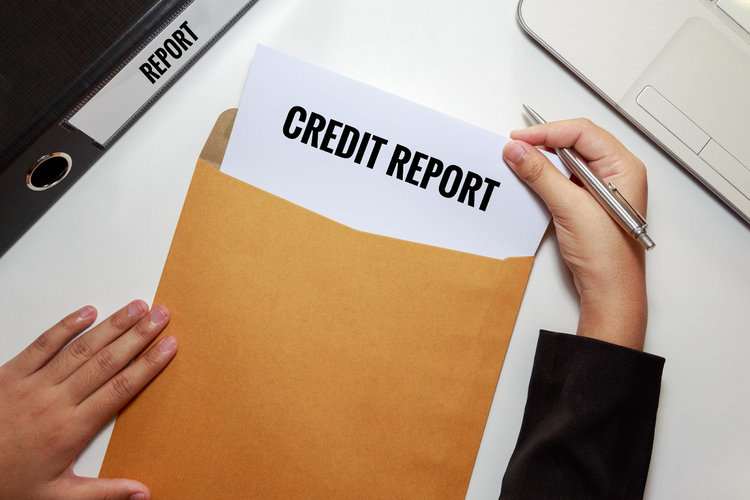 A hand pulls a document labelled "CREDIT REPORT"