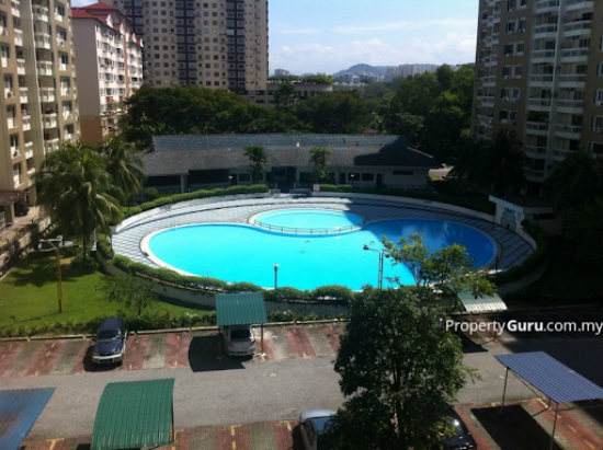 Aerial view of a figure-eight-shaped swimming pool surrounded by high-rise apartment buildings