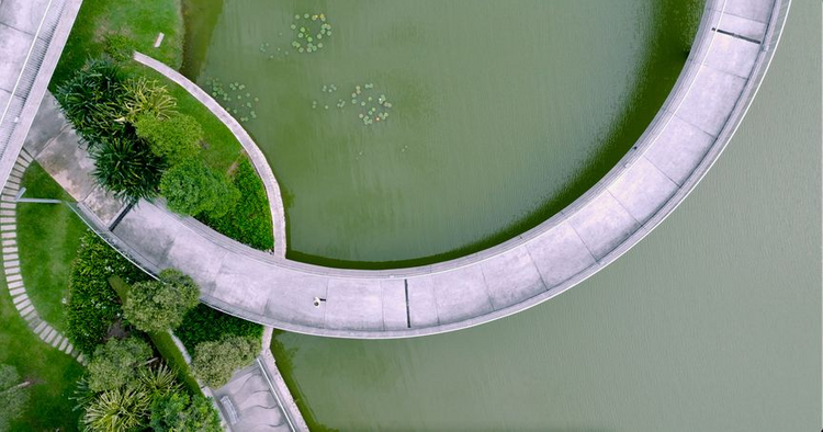 Drone shot of a curved pedestrian bridge