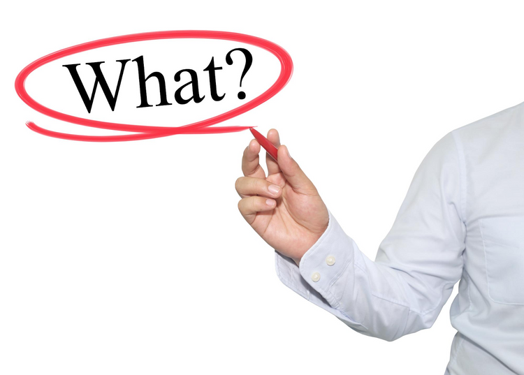 A person in a white shirt drawing a red circle around the word "What?".