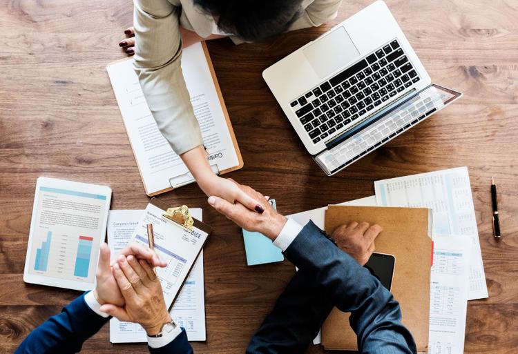 Business people shaking hands together