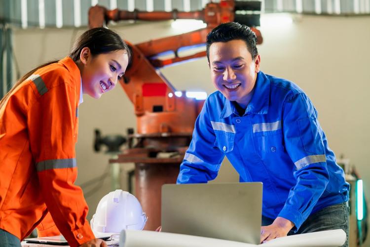 Two engineers (a male and a female) working on a project together